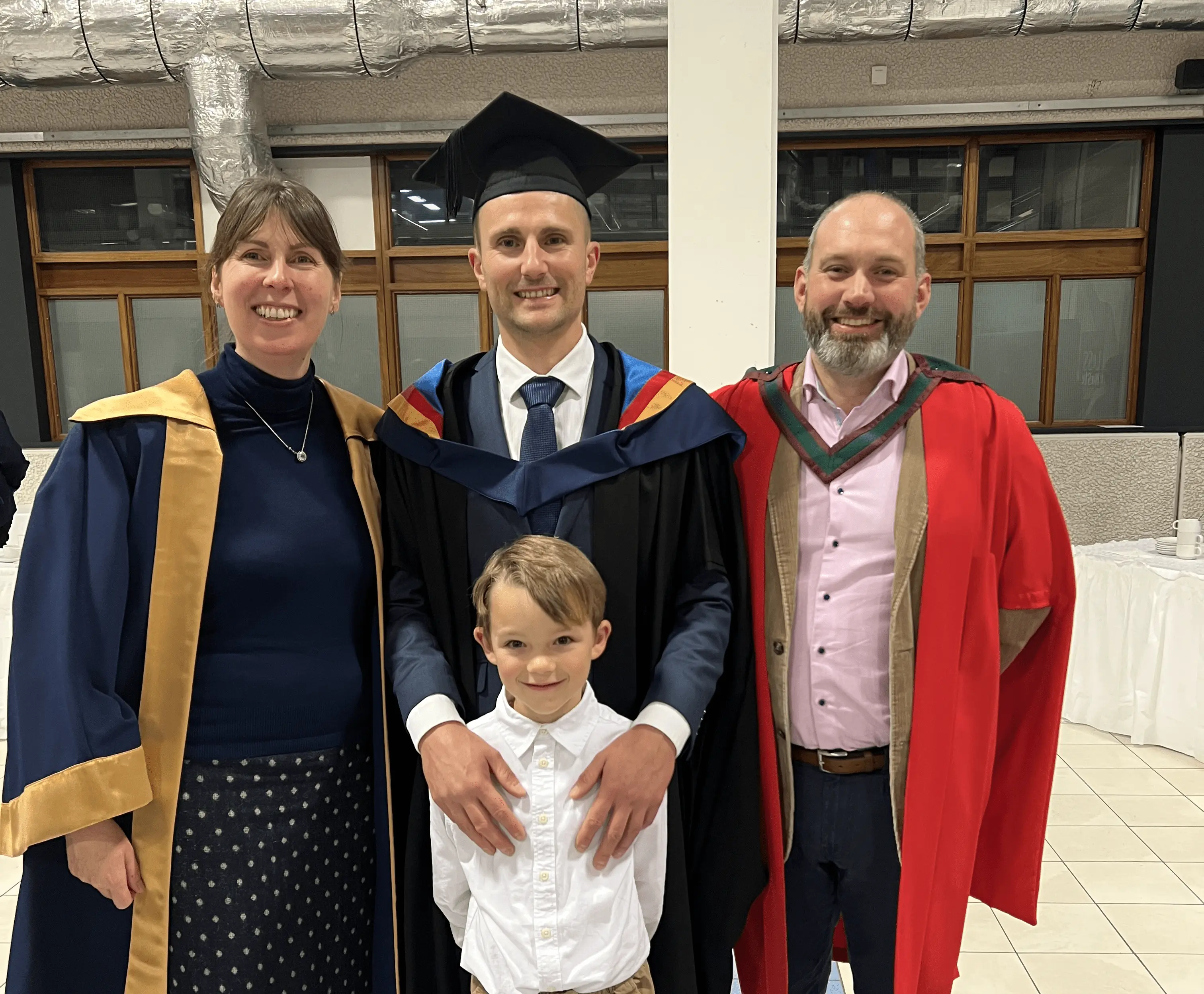 professor and student in robes and young son in MTU cyber security courses